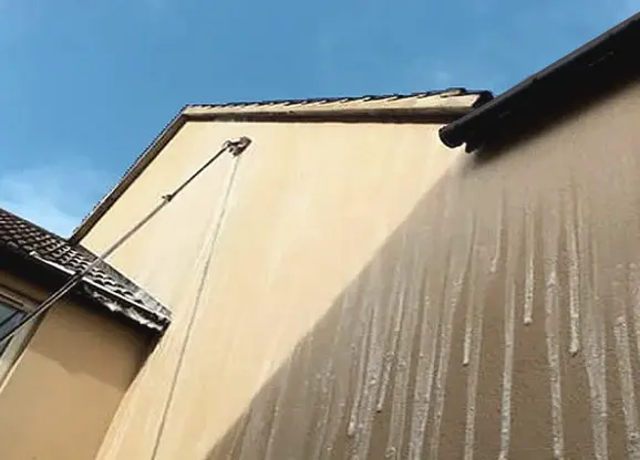 Render cleaning on exterior wall